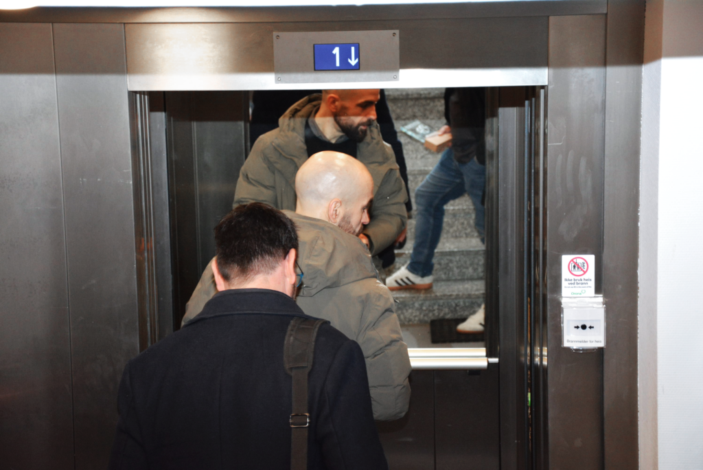 Two people enter the lift car 